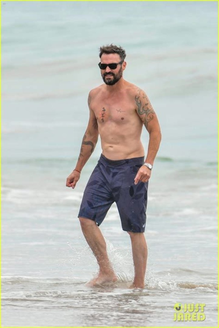 Sizzles In Board Shorts During Beach Day – Hollywood Life