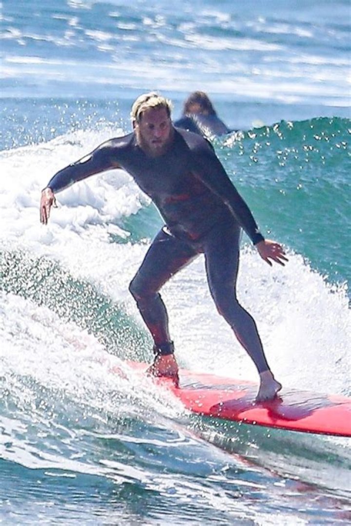 Liam Hemsworth, Dua Lipa, & More Celebs Surfing: See Photos