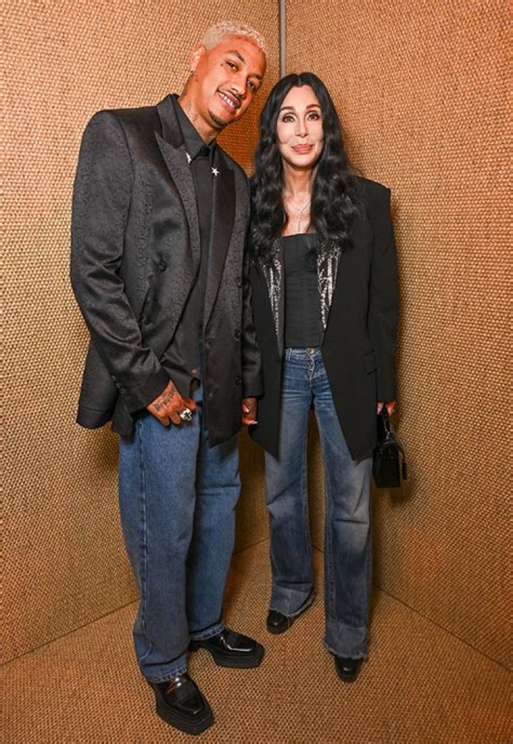 Cher, 77, Cuddles Up to Boyfriend A.E. Edwards, 38, During Rare Appearance at Paris Fashion Week: Photos