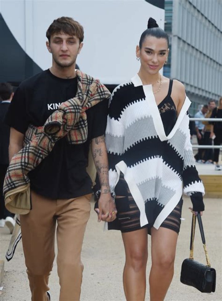 Dua Lipa & Anwar Hadid Hold Hands While Heading To Burberry LFW Show To Support His Sisters