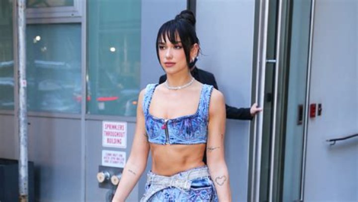 Dua Lipa Stuns In Versace All Denim Look: Crop Top, Mini, Boots & Jacket