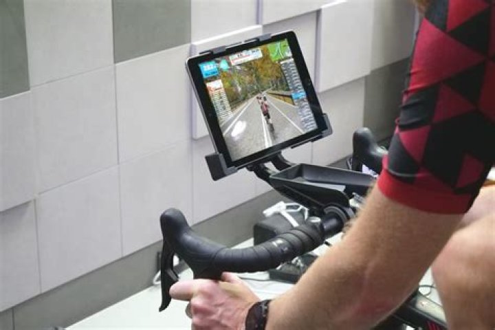 Turn Your Existing Exercise Bike Into A Peloton With This iPad Handlebar Mount That Makes Watching Videos Easy