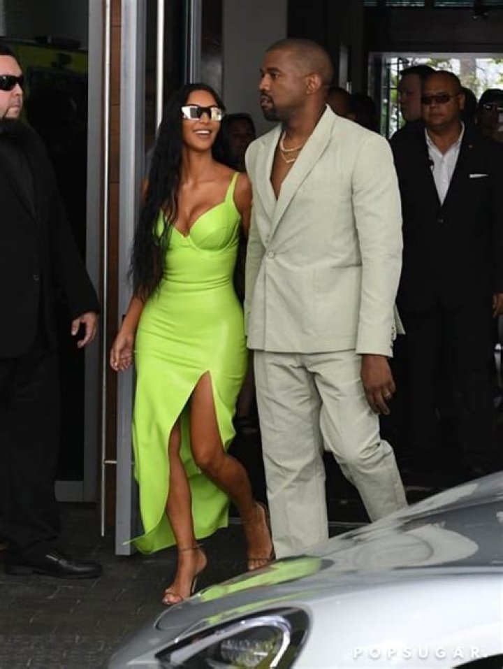 Kim Kardashian Slays In Tight Green Dress & Kanye Rocks Mint Green Suit At 2 Chainz’s Wedding