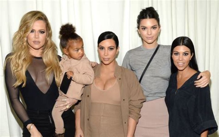 Kylie Jenner, Kim Kardashian, & All The Sisters Reunite For ‘Spice Girls’ Family Pic Crashed By Saint