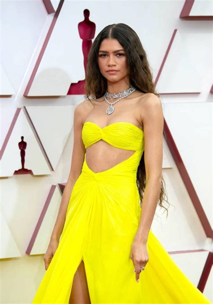 Paulina Porizkova, 56, Wows In Gold Gown Cuddling Up To Aaron Sorkin At the Oscars