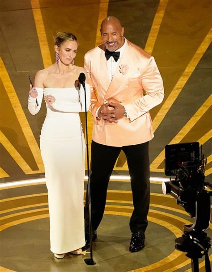 The Rock Sits On Emily Blunt’s Lap Backstage At The Oscars: Photo – Hollywood Life